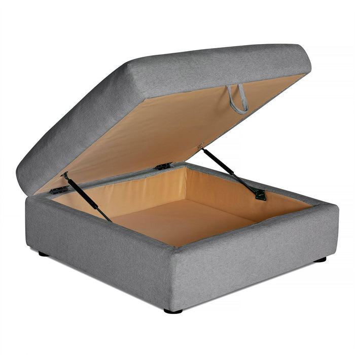 The Lugano Storage Ottoman is a square, grey Italian luxury piece with a hinged lid revealing spacious interior storage. Supported by metal hinges, lined with beige fabric, and standing on small black feet, it makes a perfect addition to any sectional configuration.