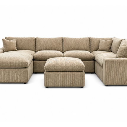A large, plush gray sectional sofa with a matching ottoman is displayed in a showroom. A sign above reads, MY CLOUD: The Worlds Greatest & Most Comfortable Sofa. A bison image is in the background.