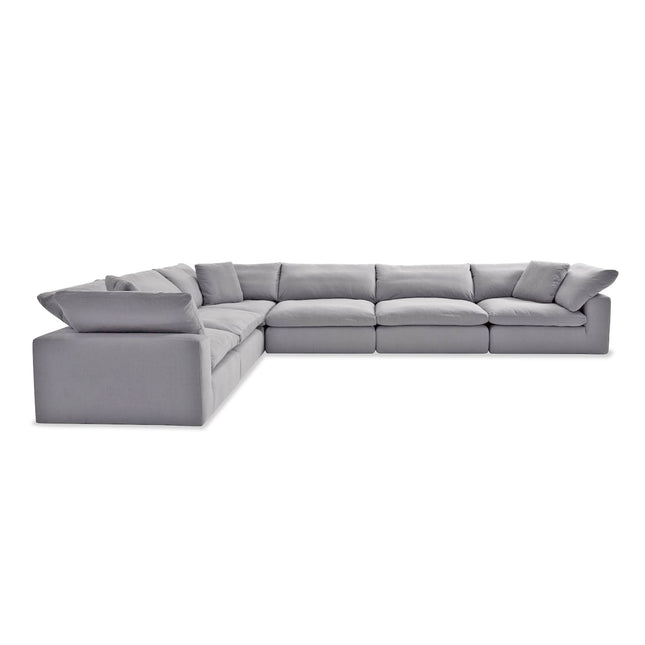 A large, modern L-shaped gray sofa with plush cushions, set against a white background. Appears comfortable and spacious, perfect for a living room. Comes with Free Fabric Swatches.