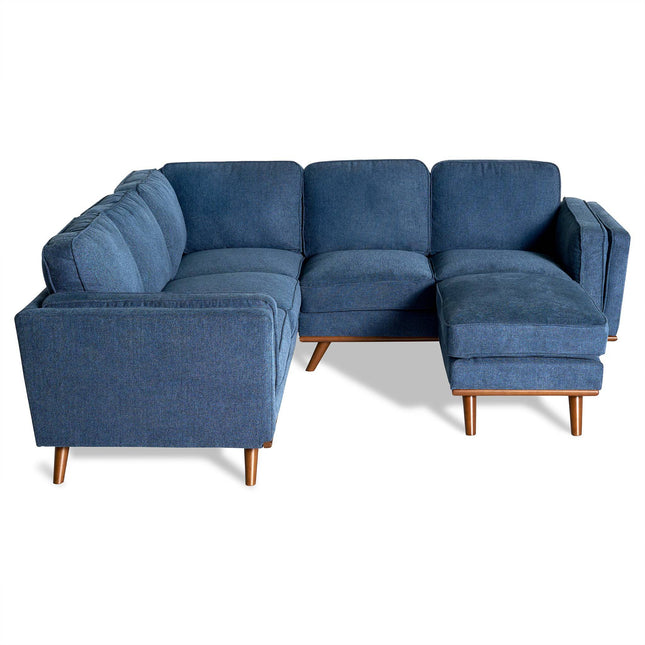 The Maddox is a contemporary blue sectional sofa with mid-century flair, elegant wooden legs, and an L-shape design. It’s ideal for a stylish living room, offering soft plush fabric and ample seating for relaxation.