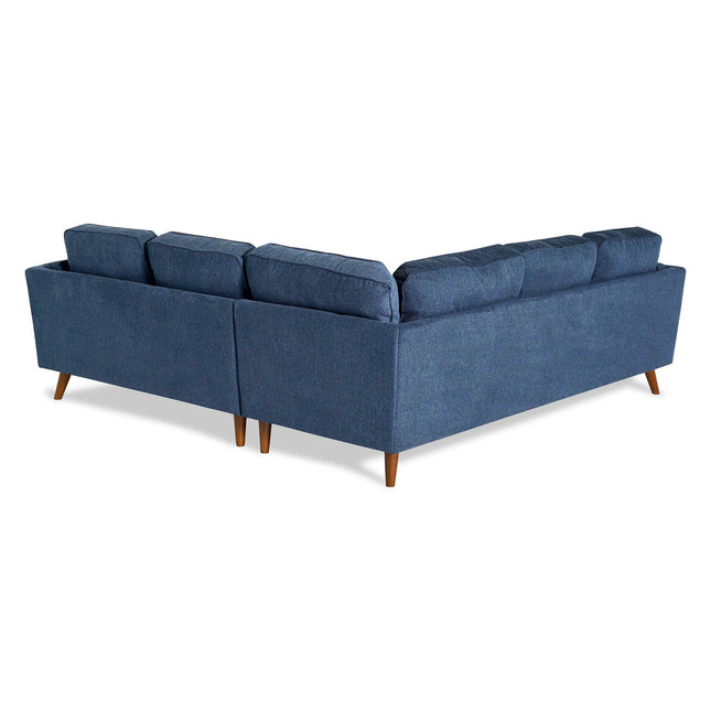 The Maddox is a mid-century modern blue sectional sofa with an L-shaped design, cushioned backrests, and wooden legs. Perfectly positioned diagonally in your living room, it beautifully displays its back and side views.
