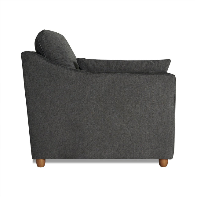 Side view of the My Cloud Slope Chair, featuring a dark gray cushioned back and seat supported by short, round wooden legs. This comfortable piece offers a modern, minimalist design ideal for any living space.