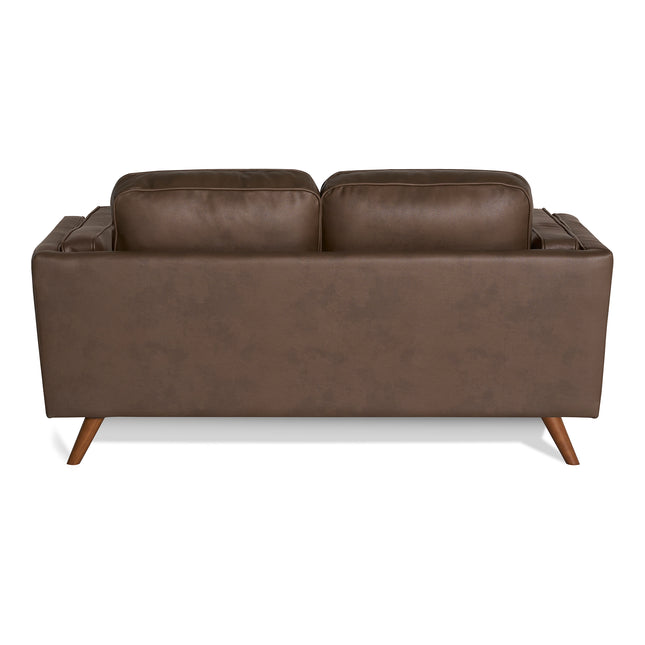The Maddox Loveseat, shown from the back, is a dark brown leather piece with two cushion backs. It embodies a mid-century modern design with angled wooden legs and a slightly textured finish, seamlessly merging minimalist and contemporary styles.