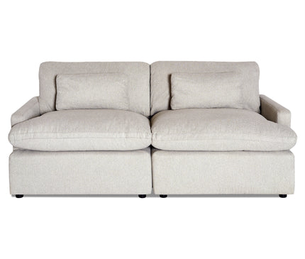 The My Cloud 2 Piece is a light beige, two-seater sofa featuring plush cushions and pillow-style armrests. It boasts a minimalist design with a slightly textured, machine-washable fabric and offers a sturdy, contemporary appearance.