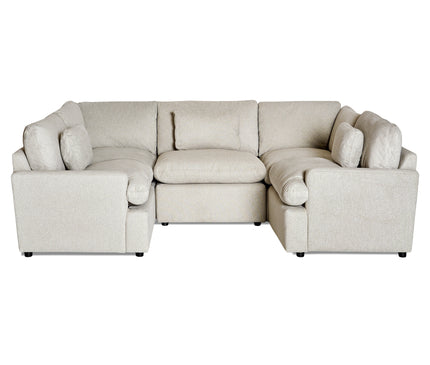 The My Cloud 5 Piece Pit is a large beige U-shaped modular sectional sofa with multiple cushions. Its soft upholstery and customizable modern, minimalistic design make it ideal for a spacious living room.