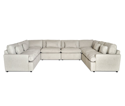 The My Cloud 8 Piece Pit, celebrated as the Worlds Greatest & Most Comfortable Sofa, is a large, light gray L-shaped sectional featuring multiple cushions. Its soft fabric ensures comfort, while short black feet provide support for its customizable design in a spacious layout.