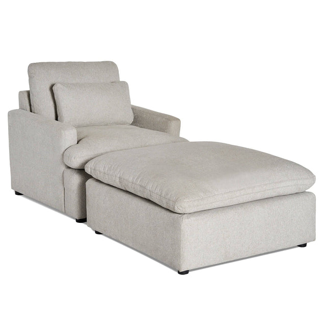 The My Cloud Chair is a light gray, modern sectional chaise lounge with cushioned backrests and armrests. It features a soft rectangular seat cushion and a matching large ottoman for customizable seating and ultimate relaxation.