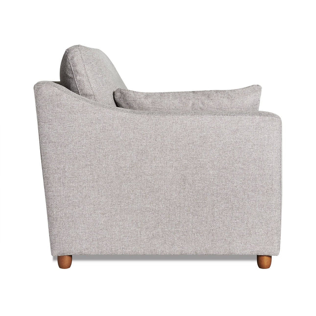 Side view of the My Cloud Slope Chair, a gray upholstered armchair with a plush cushion. This comfortable furniture has a modern design with small wooden legs, combining style and coziness.