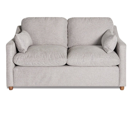 The My Cloud Slope Loveseat, part of the customizable collection, is a light gray upholstered piece with wooden legs. It features two cushions, armrests, and two small side pillows for a cozy look against a white background.