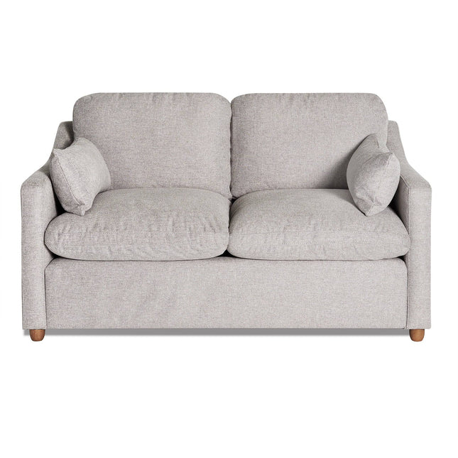 The My Cloud Slope Loveseat, part of the customizable collection, is a light gray upholstered piece with wooden legs. It features two cushions, armrests, and two small side pillows for a cozy look against a white background.