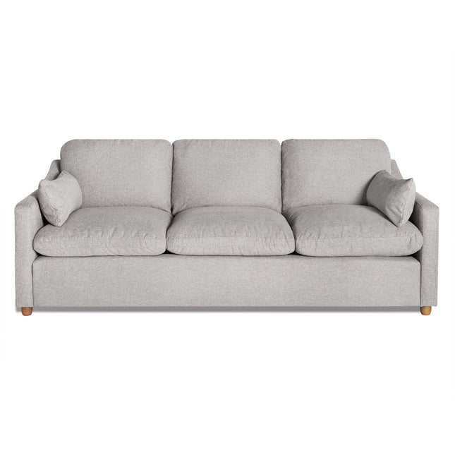 The My Cloud Slope Sofa features a modern gray design with three seat and back cushions for customizable comfort. It has sleek lines, armrests, and is supported by small round wooden legs. Two matching throw pillows on each end enhance its coziness.
