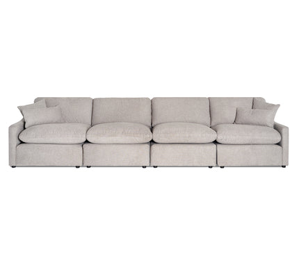 The My Cloud Slope 4 Piece Straight is a spacious gray modular sofa with four connected sections, featuring soft rounded cushions and matching throw pillows. Its minimalist design allows it to sit gracefully against a white backdrop.