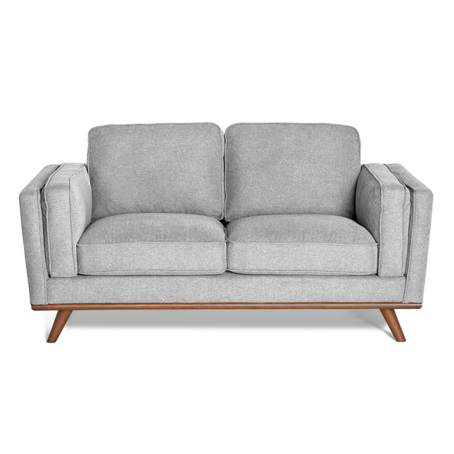 The Maddox Loveseat features a modern gray design with plush cushions and rectangular armrests, set on a wooden base with angled legs. Its mid-century modern style is minimalist, providing a clean and stylish look.