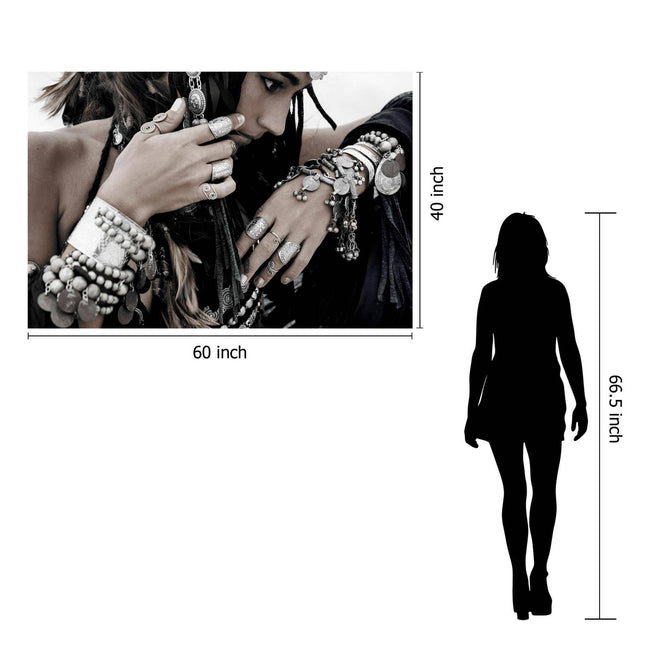 A woman wearing Boho Jewels—rings, bracelets, and necklaces—poses with her hand near her face. The museum-quality artwork is shown next to a silhouette for scale: it measures 60 inches wide by 40 inches tall.