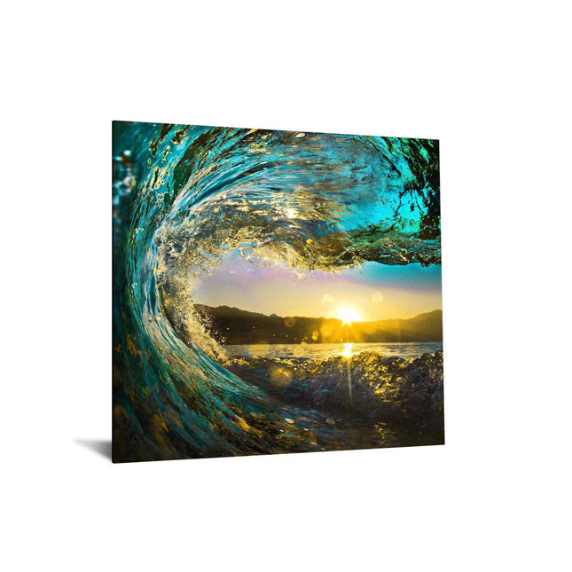 The Tidal Wave canvas print showcases a vibrant ocean wave curling towards the viewer, with sunlight illuminating turquoise waters. A sunrise or sunset casts warm hues over distant hills, creating a museum-quality piece ideal for any home or office space.