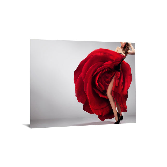 In a striking Rosie Leg dress shaped like a large red rose, petals cascade theatrically around the body. The plain white background heightens the bold impression of this museum-quality attire, while black high heels complete the ensemble.