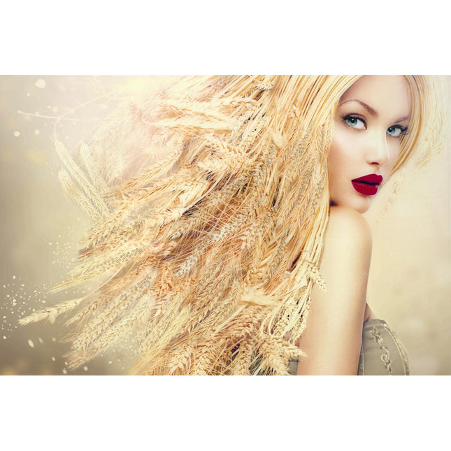 A woman wearing vibrant red lipstick poses with her head turned, showcasing a cascade of wheat woven into her long blonde hair. The softly blurred, warm-toned background resembles museum-quality artwork, perfectly highlighting the earthy elements of Wheat Head..