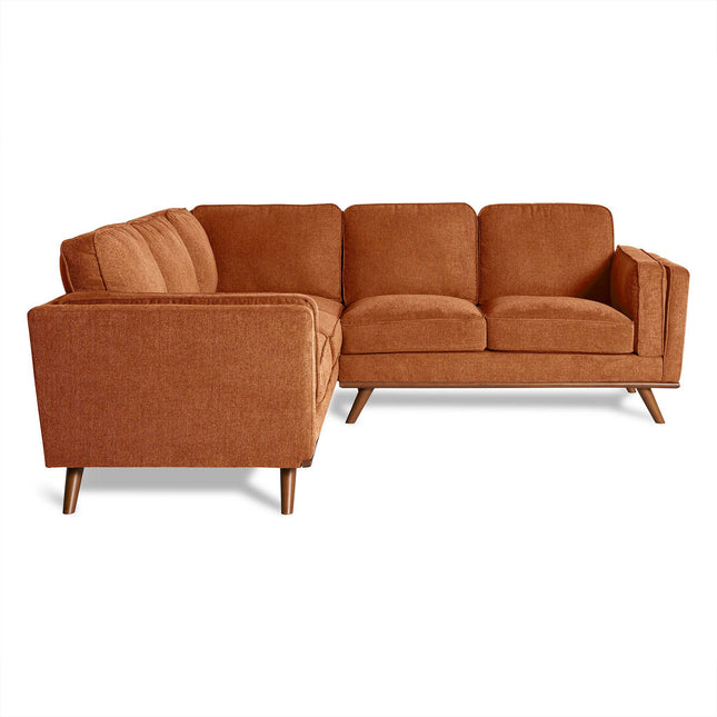 The Maddox is a brown sectional sofa that fits perfectly into any living room with its modern U-shape design, providing ample seating. It features three cushions and wooden legs, seamlessly blending into a mid-century modern aesthetic.