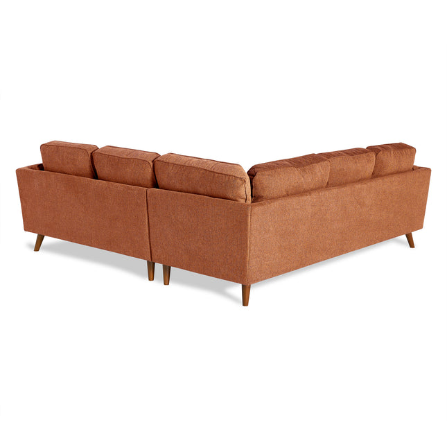 The Maddox L-shaped sectional, in a brown hue with wooden legs, enhances the living room with its mid-century modern design and plush cushions, all set against a plain white backdrop.