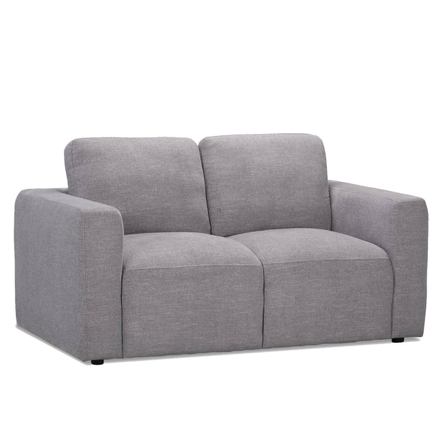 The gray Lugano Loveseat embodies Italian luxury with its minimalist design, plush cushions, wide armrests, and flat backrest. Its textured fabric upholstery offers a modern yet cozy vibe against a pristine white backdrop.