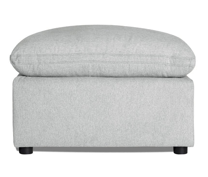 Discover the My Cloud 30 Ottoman, featuring light gray upholstery, a rectangular base, and cushioned top. It rests on four small round black legs, offering style and comfort for any space with customizable options.