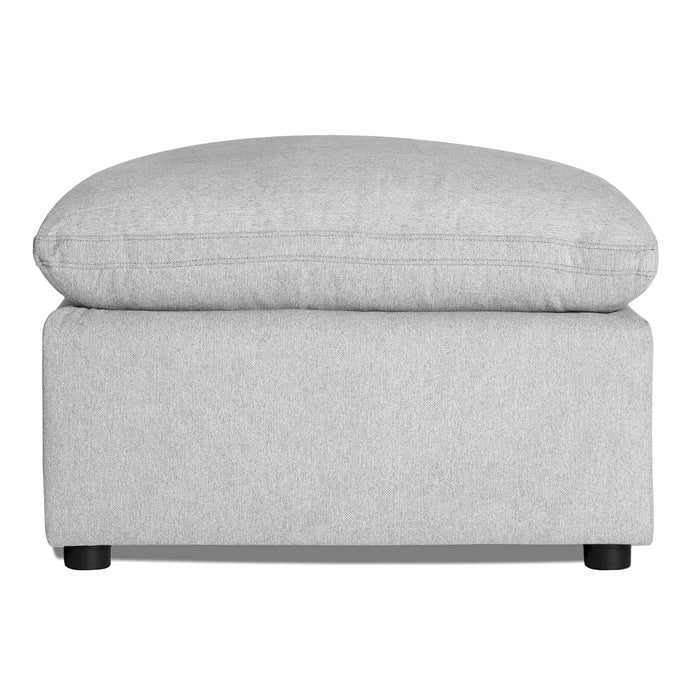 Discover the My Cloud 30 Ottoman, featuring light gray upholstery, a rectangular base, and cushioned top. It rests on four small round black legs, offering style and comfort for any space with customizable options.