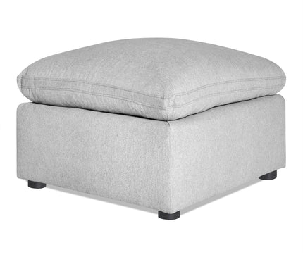The My Cloud 30 Ottoman showcases a gray, plush cushion on a sturdy base with four black legs. This customizable piece combines minimalist design with comfort and style, perfect for any living space.