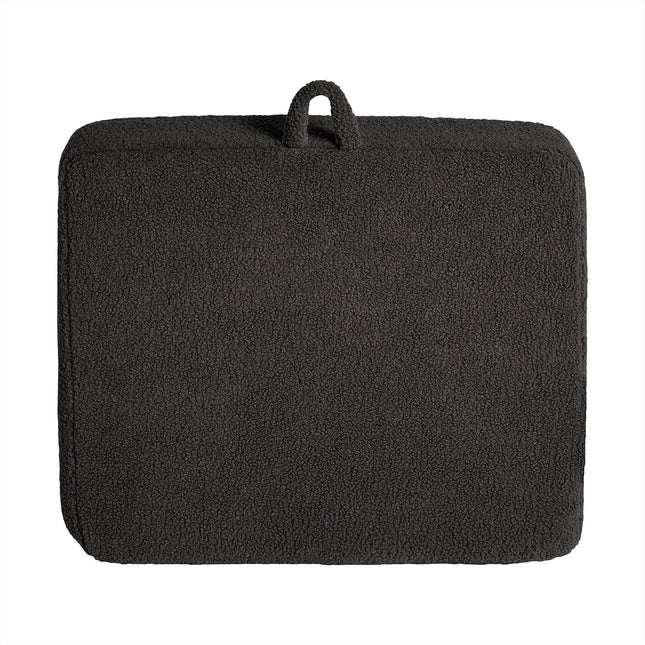 A rectangular, textured dark gray cushion with rounded edges and top loop for carrying or hanging is crafted from soft Sherpa fabric, boasting a fleece-like surface for added comfort. It perfectly complements the My Cloud Kidz Chair to create a cozy and inviting space.