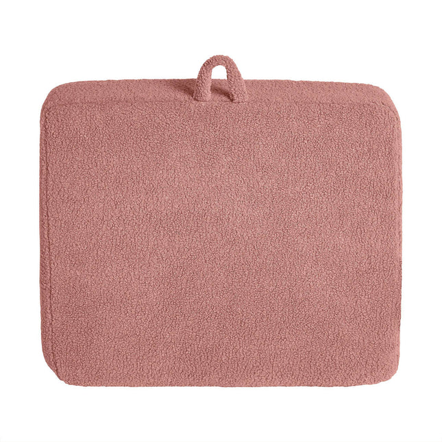 A soft pink rectangular bath mat with a plush Sherpa fabric surface and a small fabric loop enhances modern minimalism, pairing stylishly with the customizable My Cloud Kidz Chair.