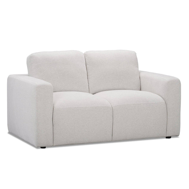 The Lugano Loveseat, with plush cushions and wide armrests in light gray, embodies Italian luxury through its modern, minimalist design, making it an ideal addition to contemporary living room decor.
