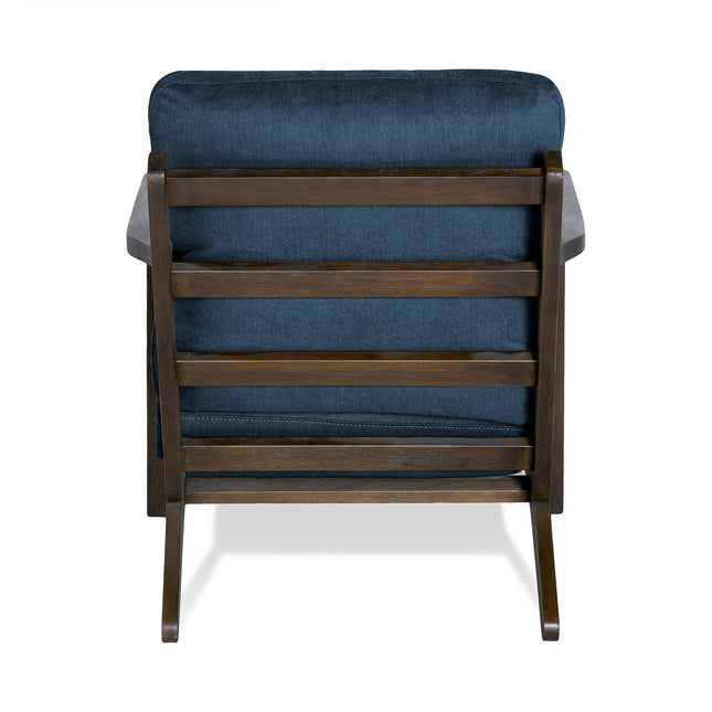 Rear view of the Peyton Chair, showcasing its classic mid-century style with a dark blue cushioned backrest, slatted wood design, sturdy armrests, and a seamless integration into any décor on a white background.