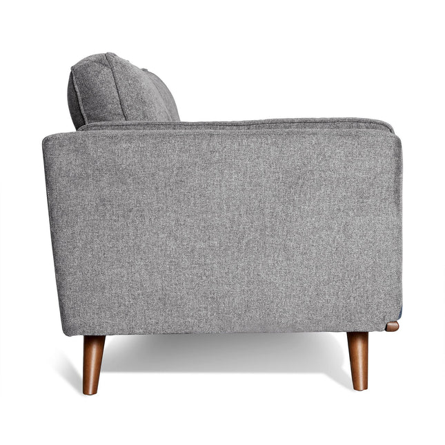 Side view of the Maddox Sofa, featuring gray upholstery and wooden legs in a mid-century modern style, set against a white background to emphasize its minimalist elegance.