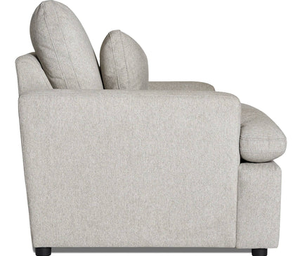 A side view of the My Cloud Chair reveals a light gray fabric sofa with two large back cushions, slightly curved armrests, and black legs. Its simple, modern design features a low profile that effortlessly combines style and comfort.