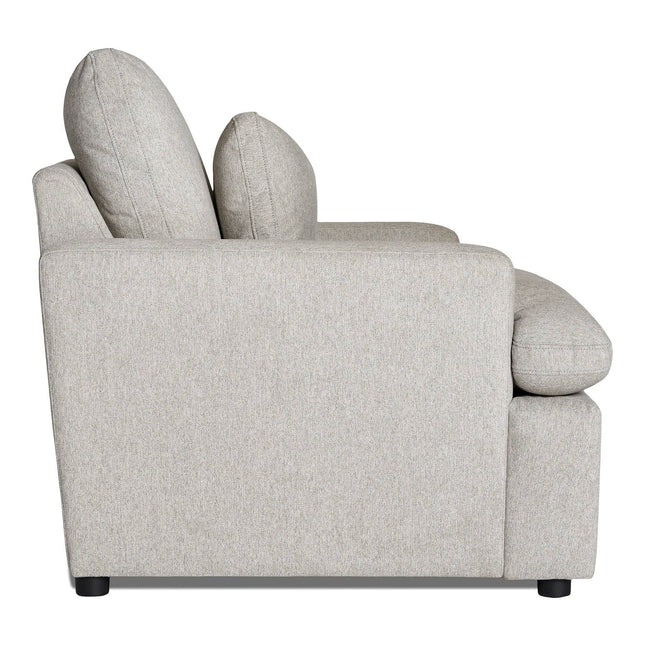 A side view of the My Cloud Chair reveals a light gray fabric sofa with two large back cushions, slightly curved armrests, and black legs. Its simple, modern design features a low profile that effortlessly combines style and comfort.