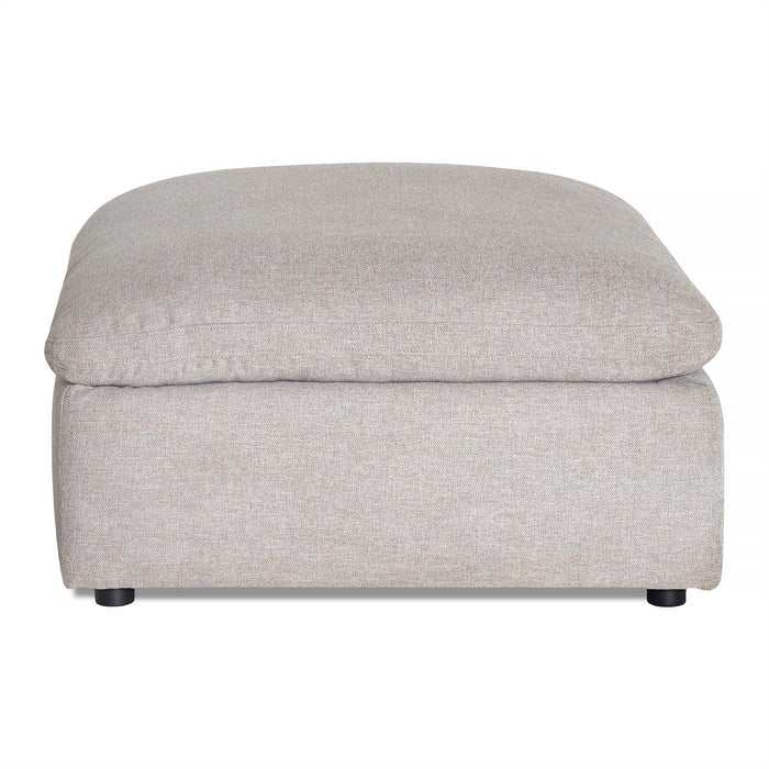 The My Cloud Slope 40 Ottoman showcases a beige upholstery with a cushioned top. Its simple, modern rectangular design and small black feet make it a comfortable, stylish addition to your customizable furniture collection.