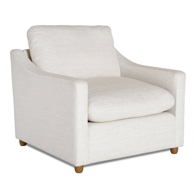 The My Cloud Slope Chair is a plush, white armchair with lightly textured fabric. It offers a cushioned seat and backrest, slightly angled armrests, and four short wooden legs, epitomizing modern comfort in customizable furniture design.