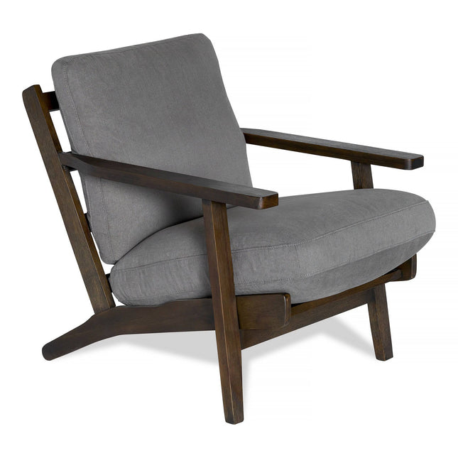 Introducing the Peyton Chair: a modern armchair with a mid-century vibe. It features a dark wood frame, plush gray cushions, angled legs, and wide armrests for stylish and comfortable seating.