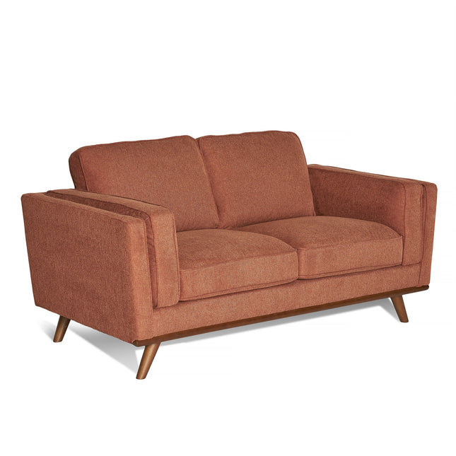 The Maddox Loveseat features brown fabric upholstery in a mid-century modern style. It has plush cushions for comfort, two seat and back cushions, angled wooden legs, and boxy padded armrests.